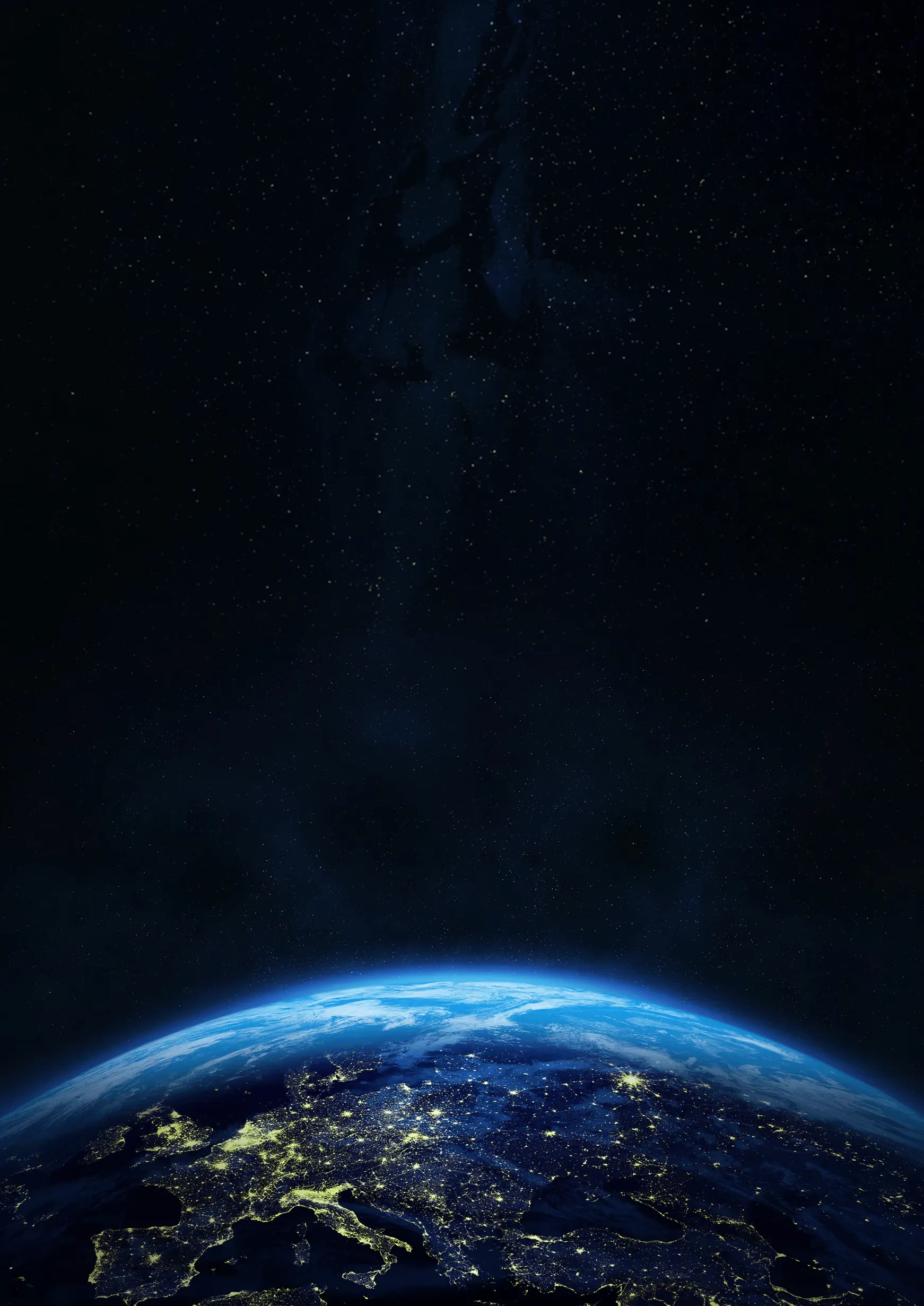View of Earth from space at night showing illuminated cities in Europe under a starry sky.