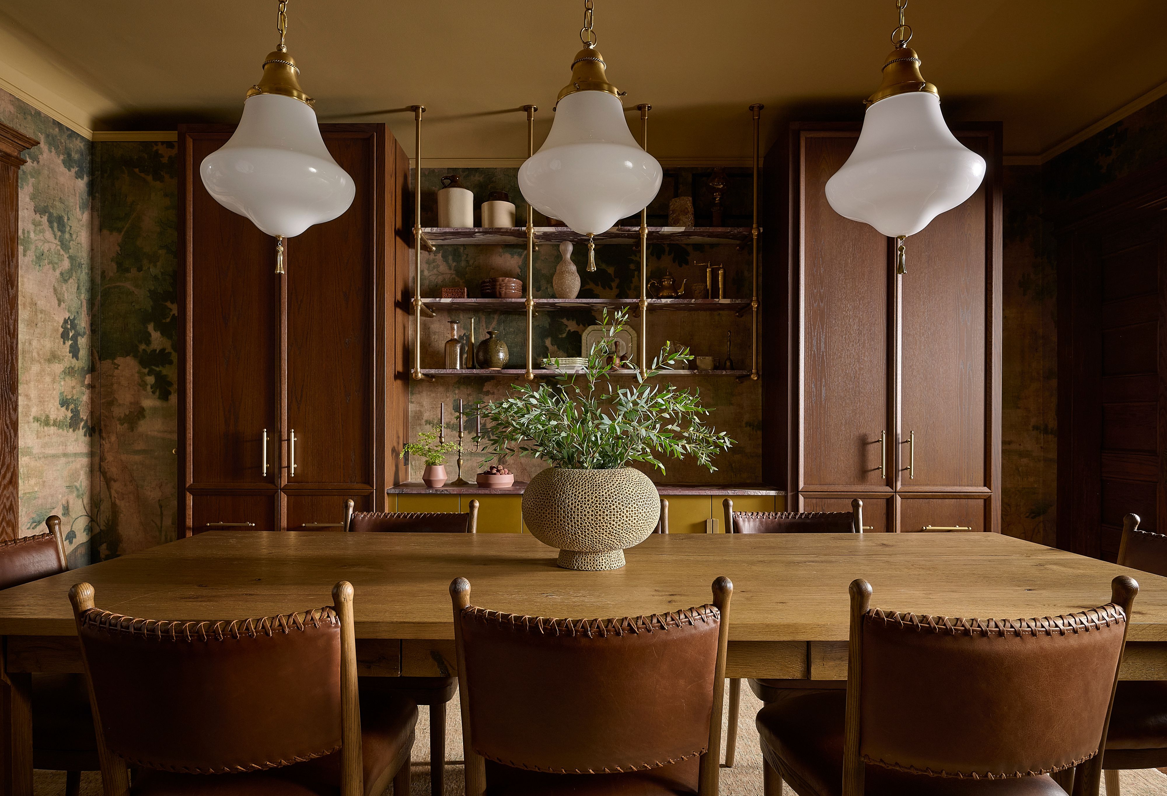 Edwardian dining room wrapped in a moody scenic wallpaper, with custom millwork, a larder pantry and a cocktail bar behind pocket doors