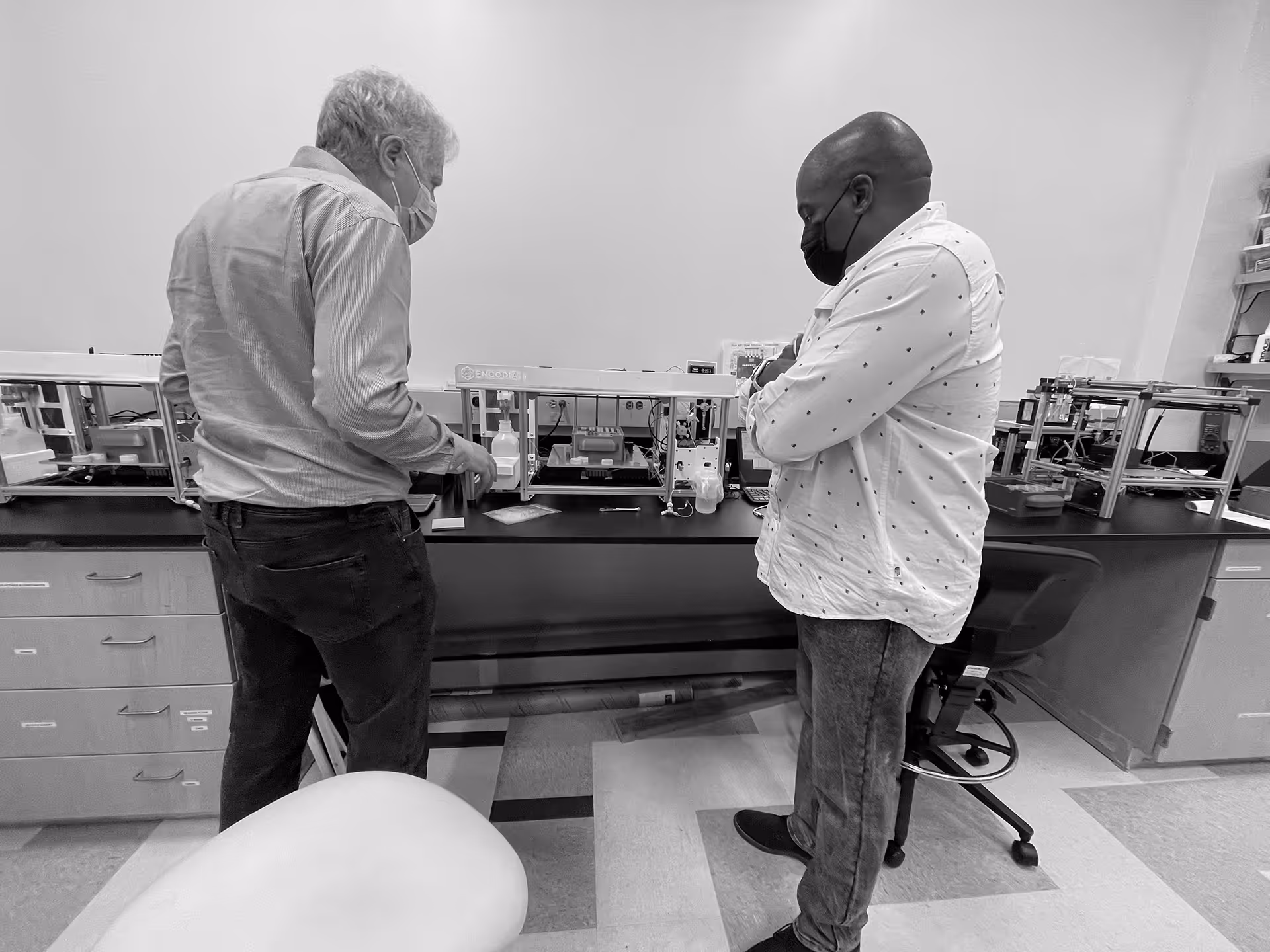 Speck Design and Encodia team reviewing the protein analysis system prototype during medical device development.