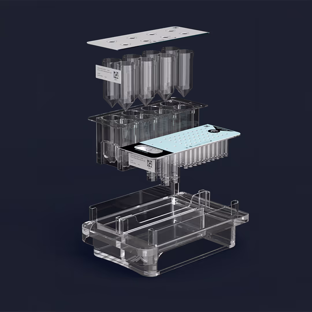Exploded view of a transparent multi-compartment laboratory tray with conical tubes and perforated plates above a base container, set against a dark background.