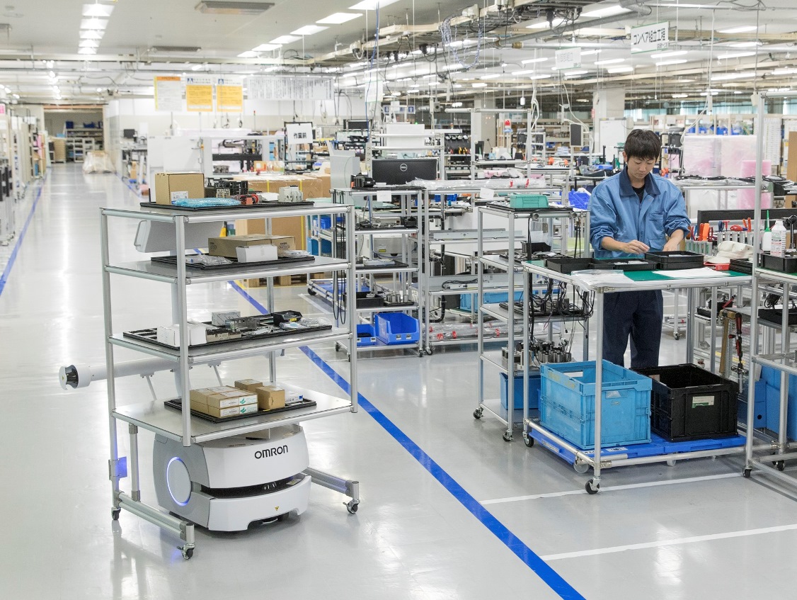 Omron mobile robot transporting materials in a logistics warehouse