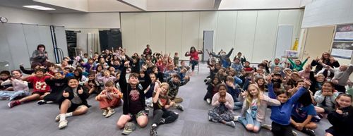 A group of elementary school students and their teachers during a reading of my book, The Old Woman and The Mouse.