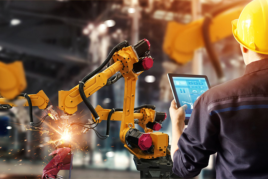 Engineer check and control welding robotics automatic arms machine in intelligent factory automotive industrial with monitoring system software. Digital manufacturing operation.