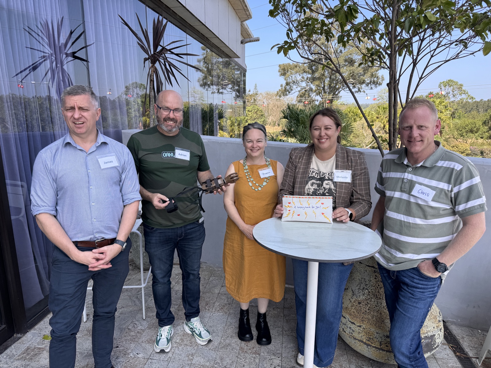 Queensland Ambulance Service leaders with the prosthetic hand built during the Helping Hands Challenge