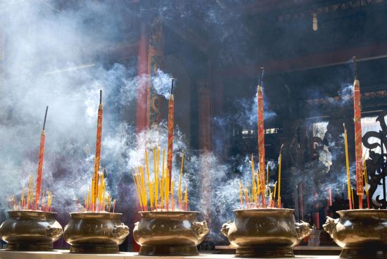 Tout savoir sur les voyages et les vacances au Vietnam: Saigon: Smoking prayer sticks in copper urns at Thien Hau Pagoda