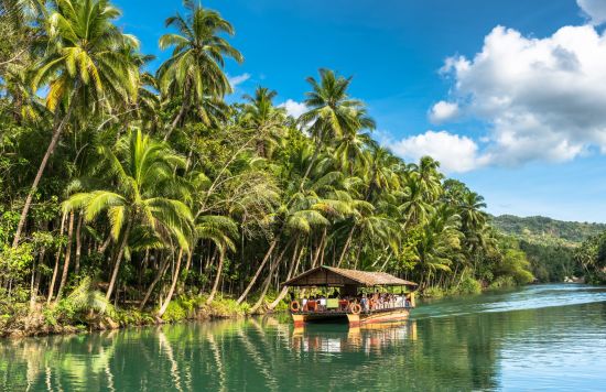 Bohol Tour: Bohol Traditional raft boat on a jungle green river Loboc