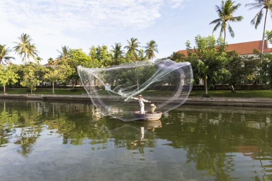 Anantara Hoi An Resort:  Fisherman at the Resort Riverfront