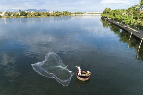Anantara Hoi An Resort:  Fisherman at the Resort Riverfront