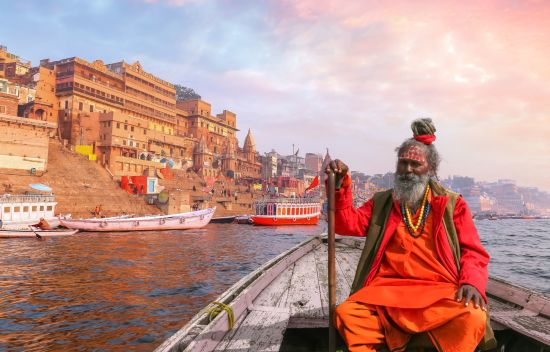 Indien für Geniesser ab Delhi: Varanasi Indian Sadhu takes a boat ride on river Ganges