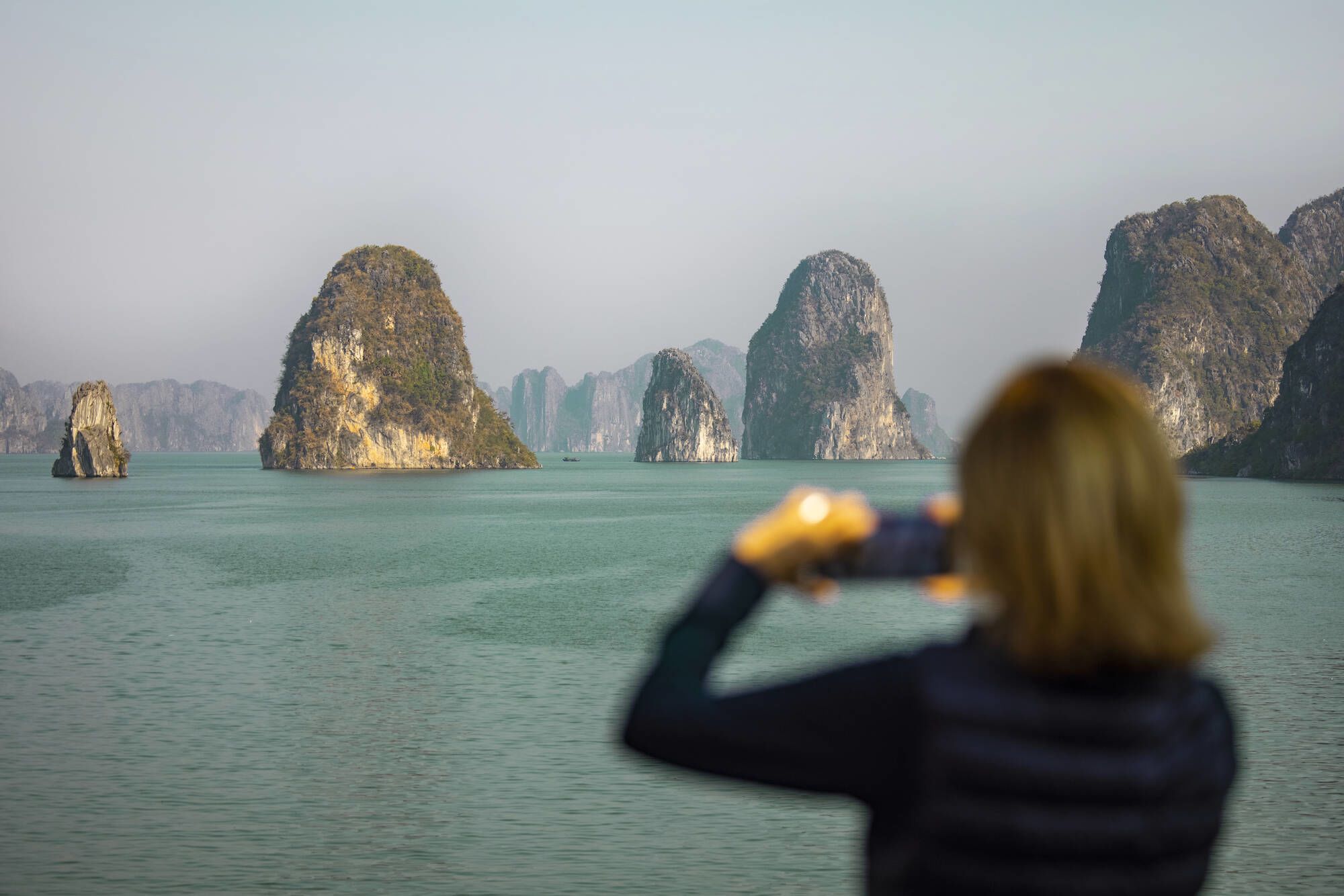 Bai Tu Long Bucht Kreuzfahrt mit «Violet» ab Hanoi: Tourist taking a photo of Bai Tu Long Bay