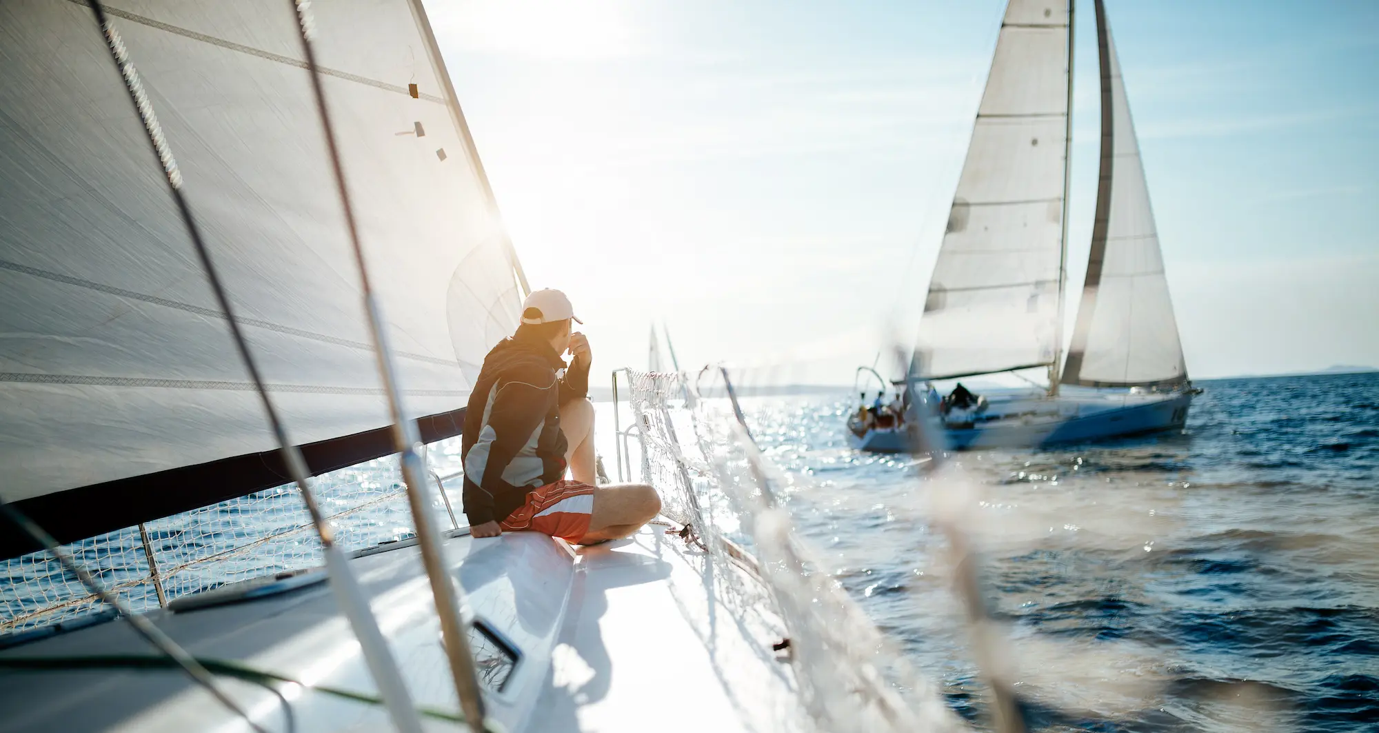 Man relaxing on sailboat after Competent Crew training