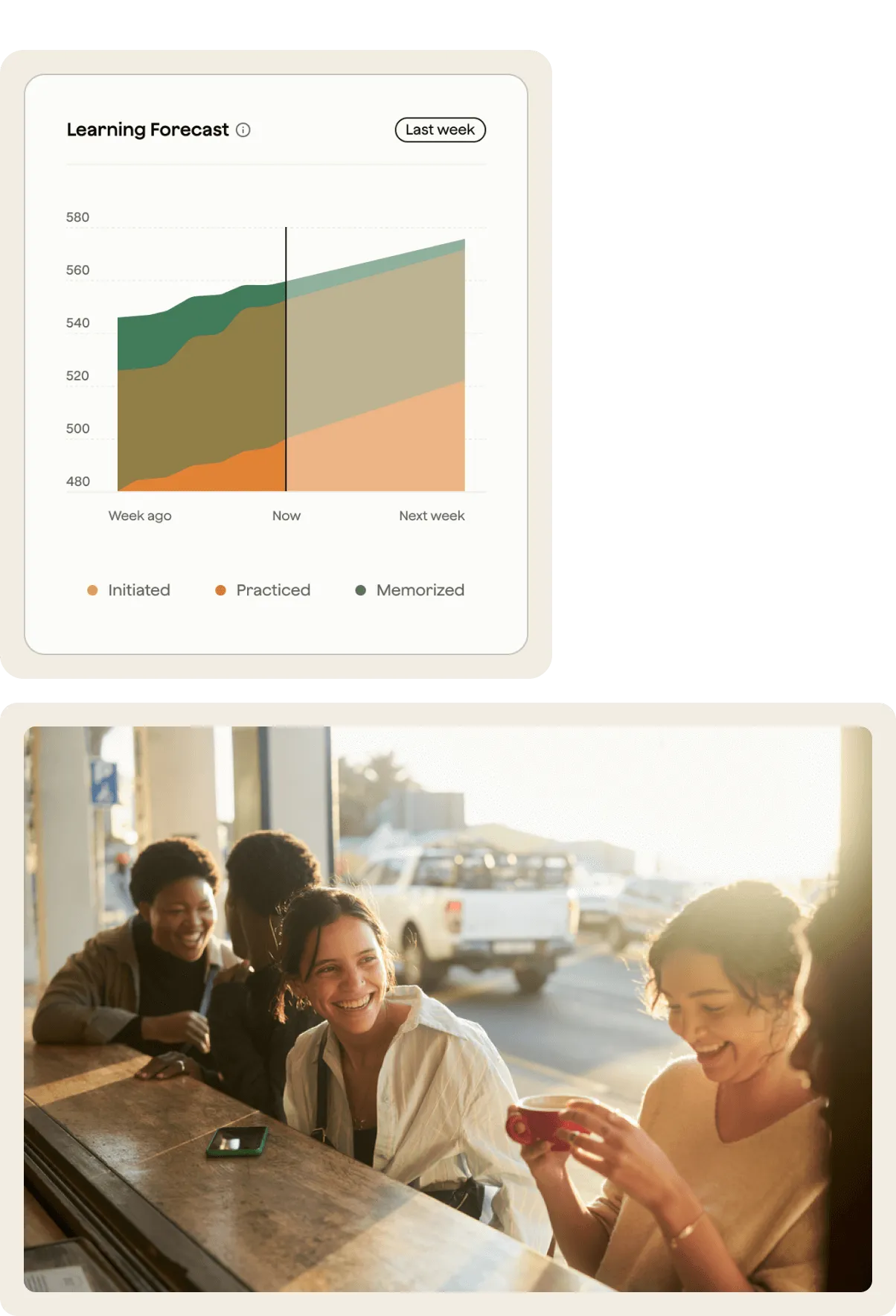 A woman sitting at a table with a cell phone in her hand.