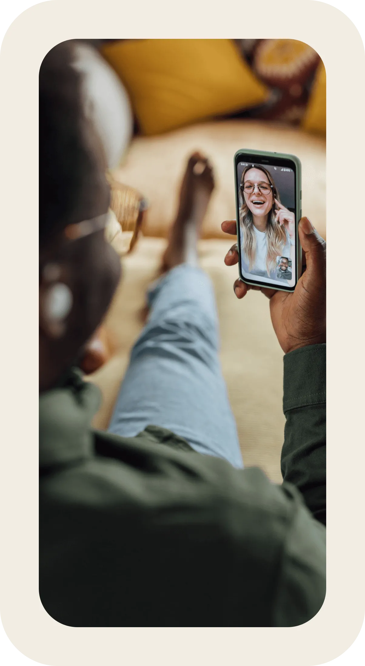 A man is holding a cell phone with a picture of a woman on the screen.