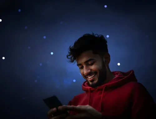A smiling trader using his mobile phone for 24/7 cryptocurrency