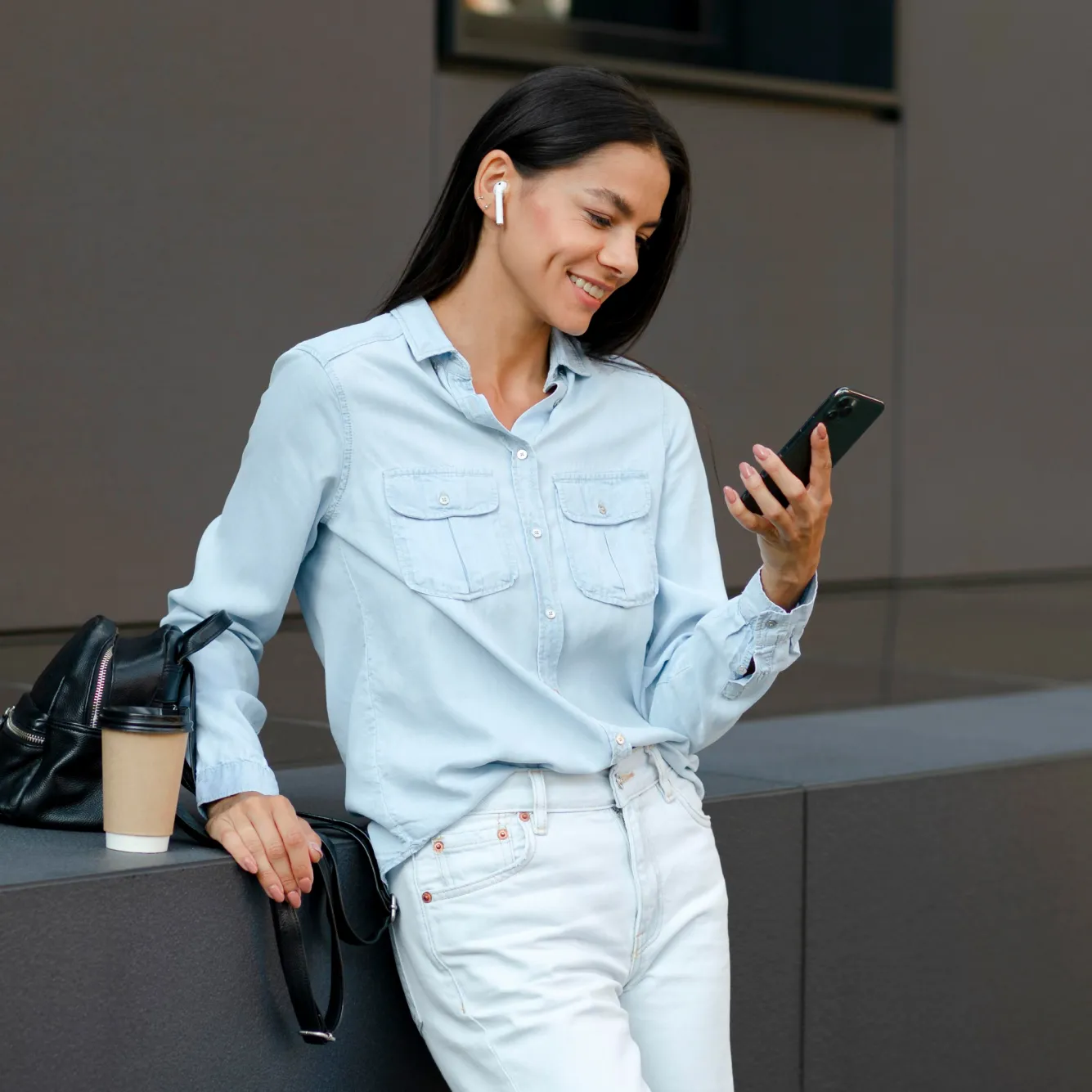 A female trader smiling while trading Hybrid Indices on the Deriv mobile app