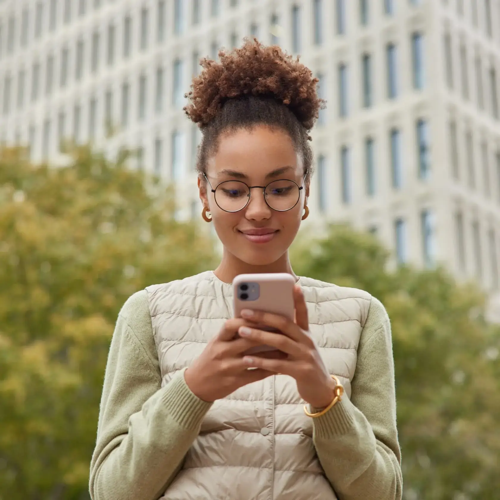 Woman using smartphone to start silver trading on Deriv platforms