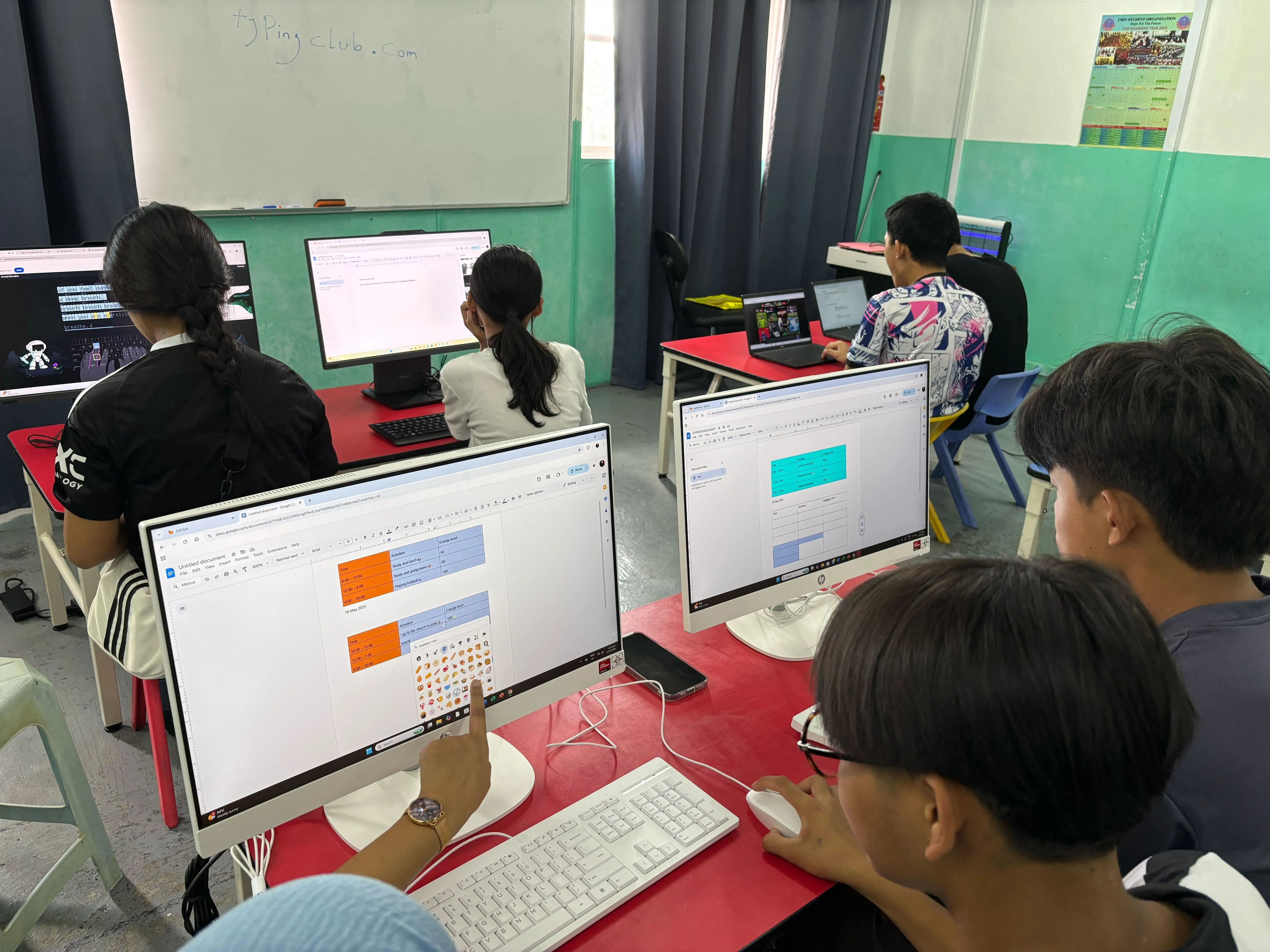 Deriv employees helping kids with their new laptops