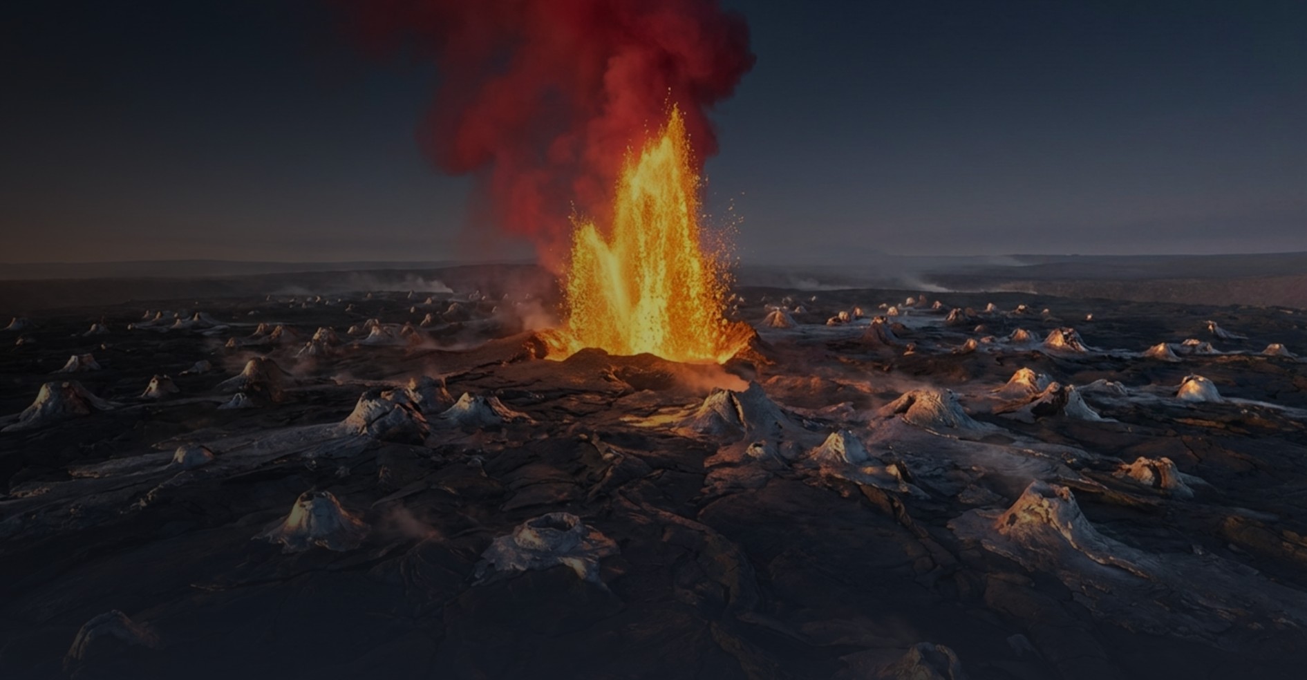 Wide landscape image of a volcanic eruption, with bright orange lava and flames shooting upward from a central vent