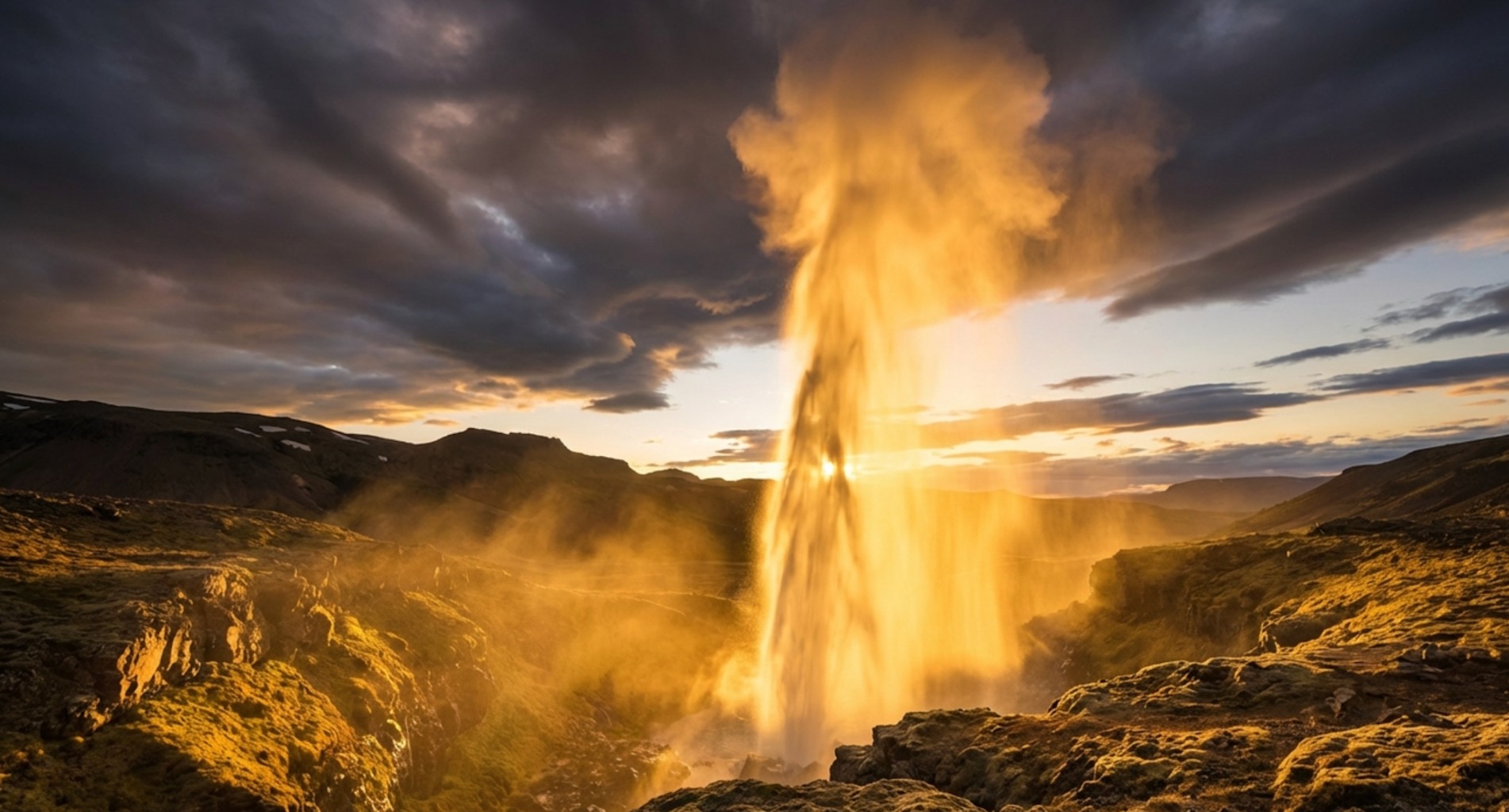 Golden waterfall illuminated by sunset under dramatic storm clouds.