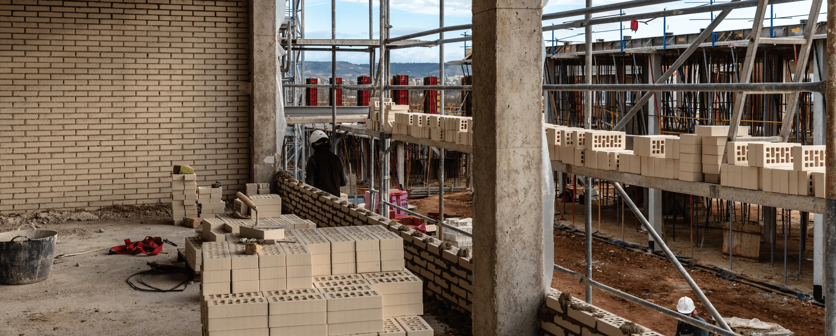 A brick building under construction with scaffolding around it.