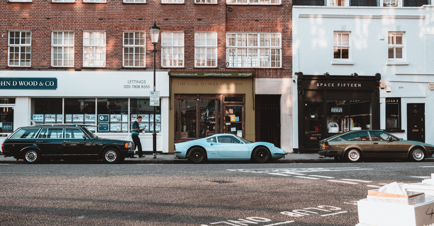 Classic cars parked on a traditional British high street