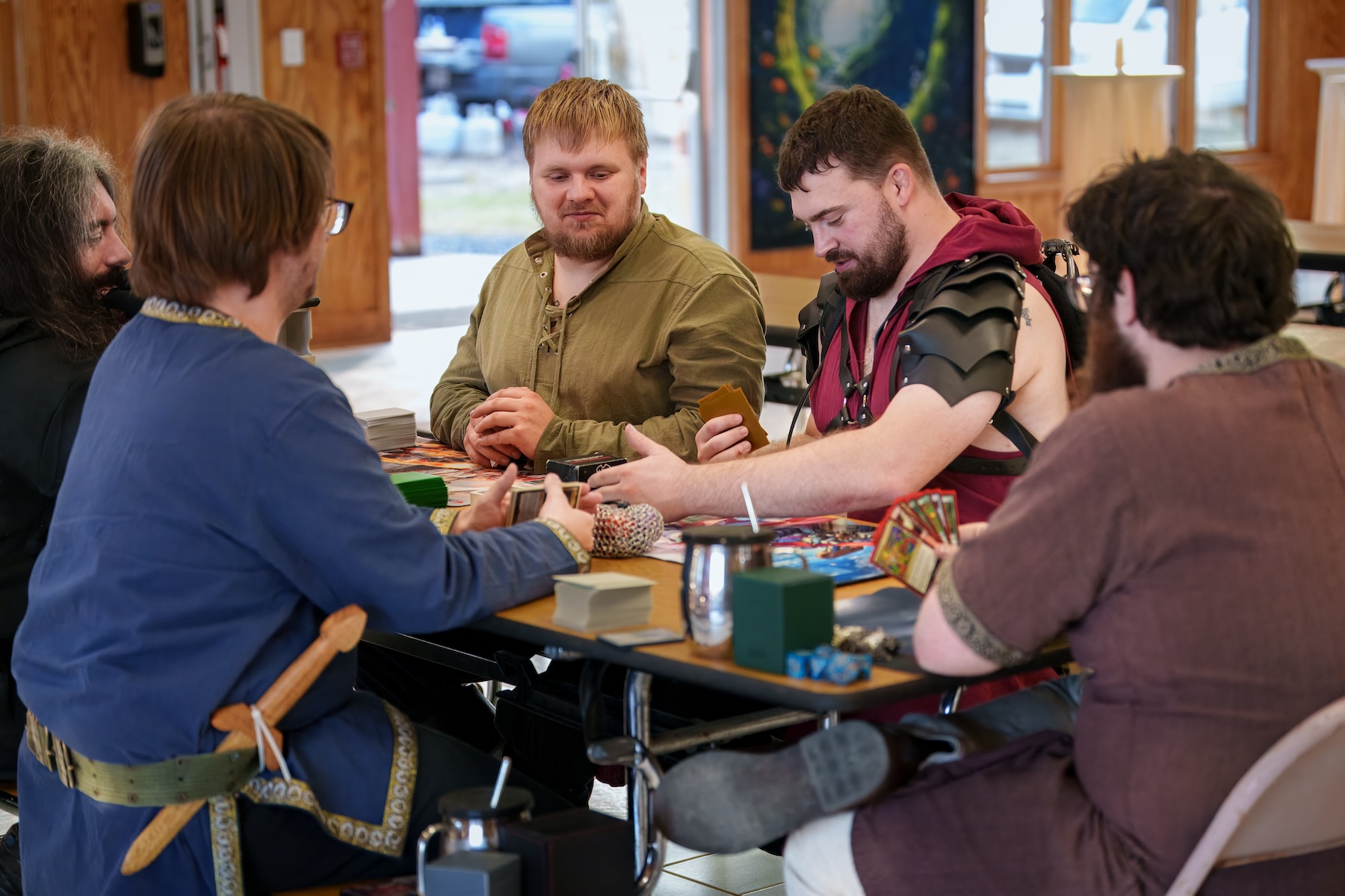 A minstrel playing music surrounded by onlookers.