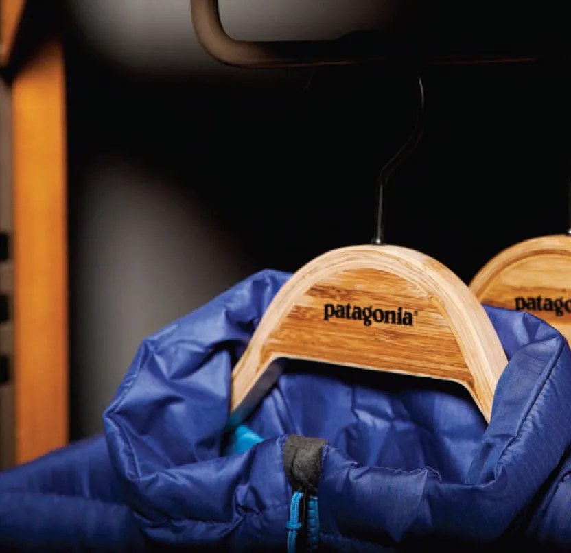 Close-up of Patagonia branded wooden hanger detail on blue outerwear showcasing fixture craftsmanship