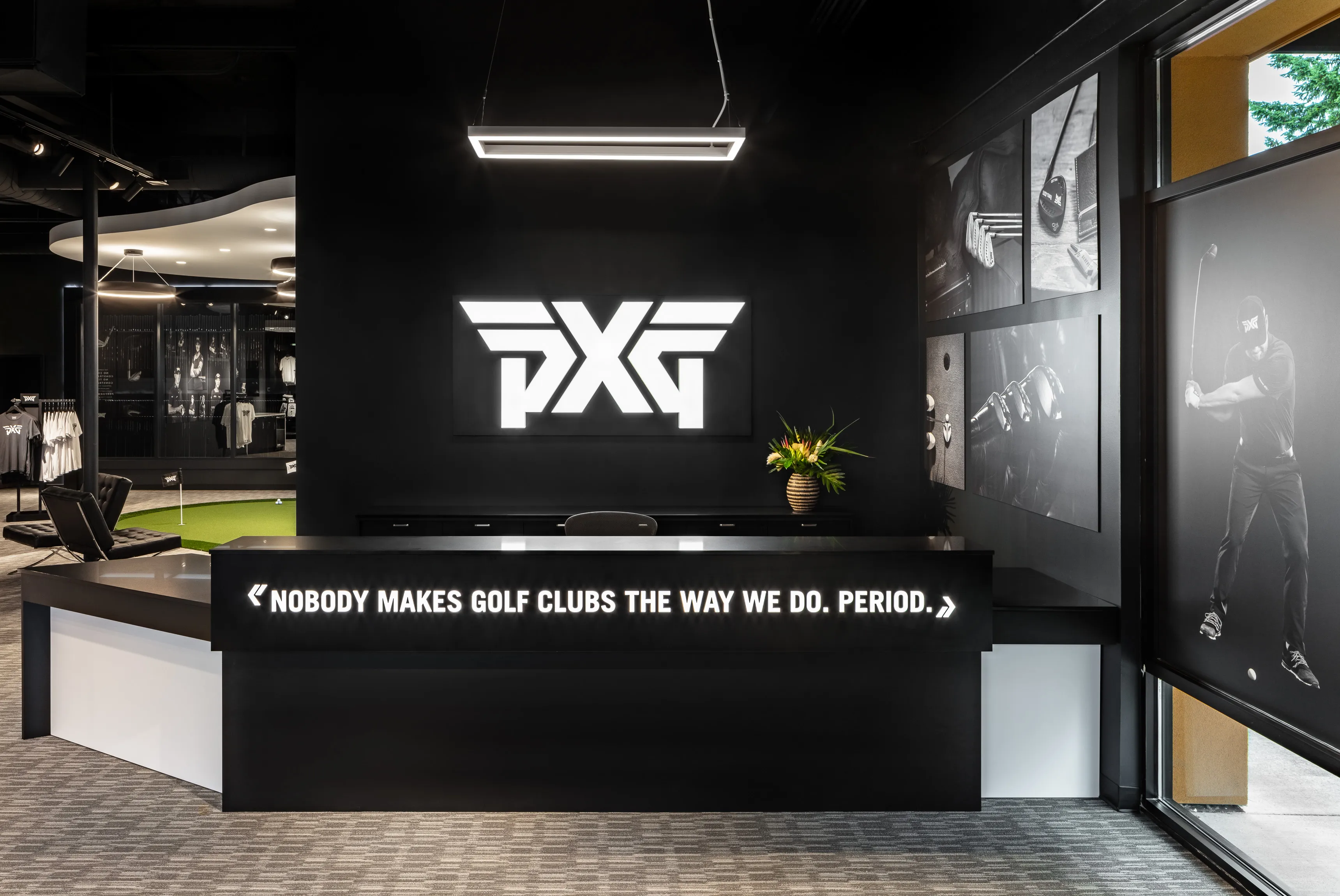 PXG golf retail store interior with modern black storefront, illuminated white PXG logo, tagline 'Nobody Makes Golf Clubs The Way We Do. Period,' and integrated golf simulator area
