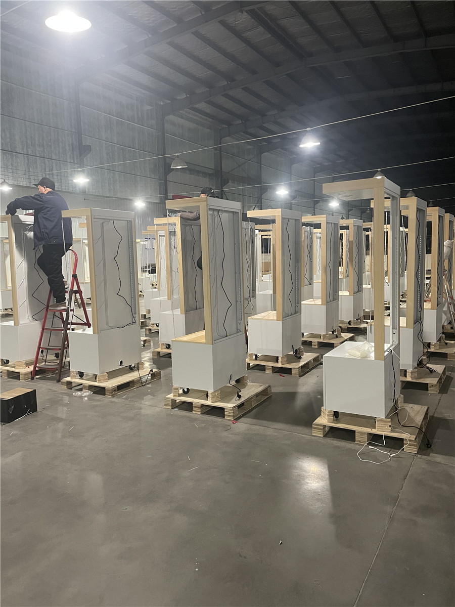 Smith Displays retail fixture manufacturing facility with multiple wooden display boxes and structures in various stages of assembly lined up on warehouse floor
