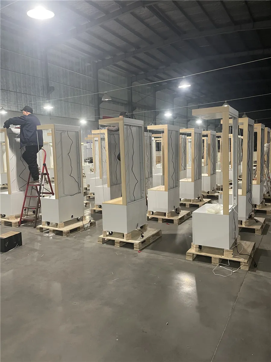 Smith Displays retail fixture manufacturing facility with multiple wooden display boxes and structures in various stages of assembly lined up on warehouse floor