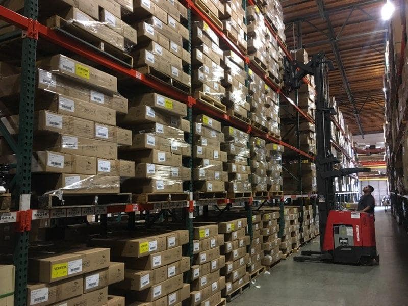 Warehouse interior with industrial pallet racking system storing stacked boxes and packaged goods