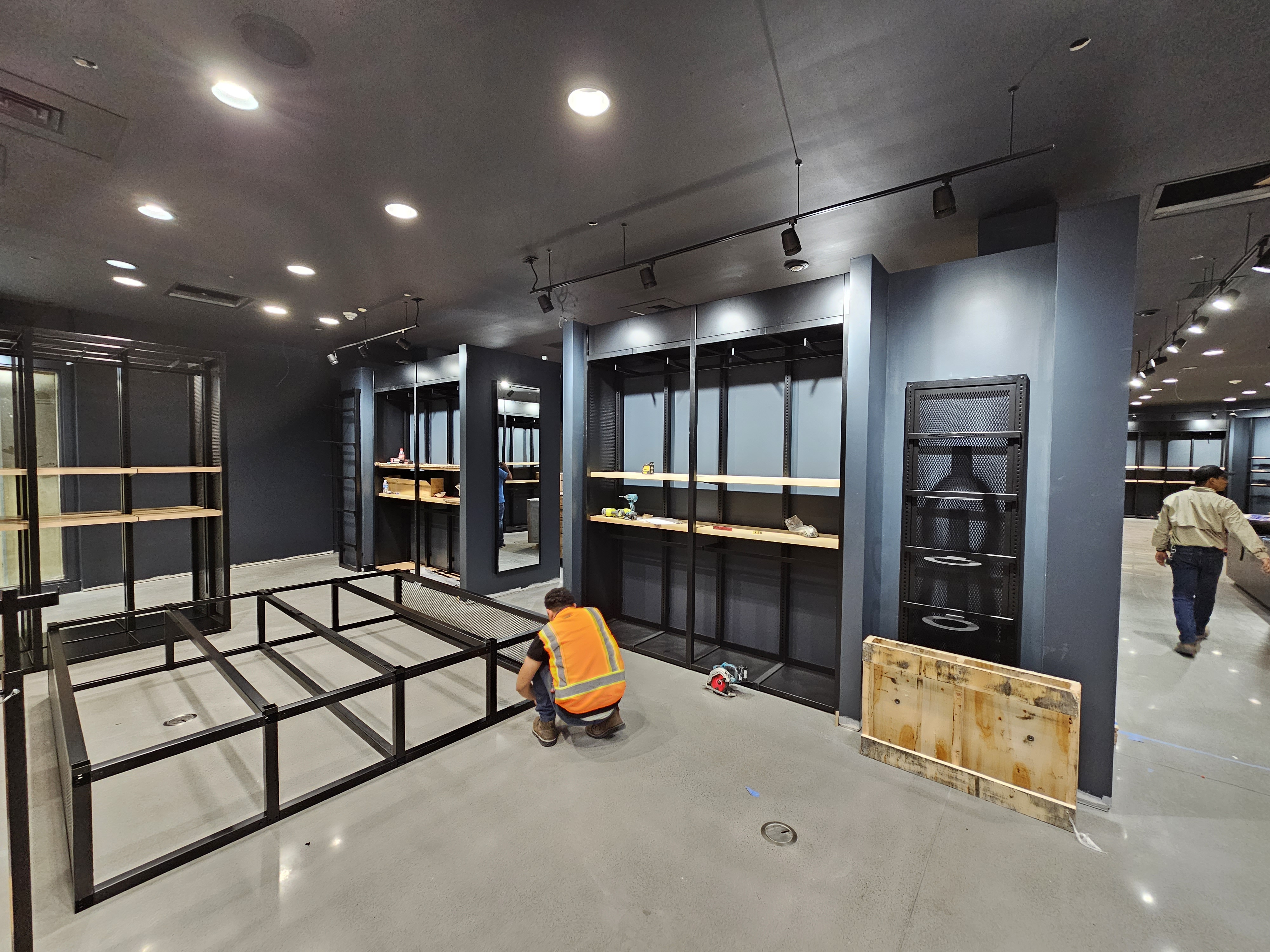 Lids retail store installation in progress with fixtures, shelving systems, and construction materials