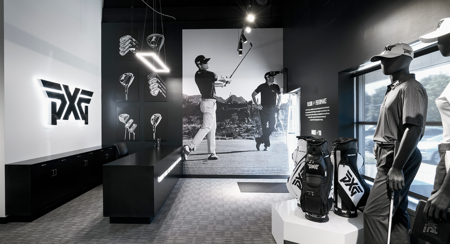 PXG Performance Studio club fitting area with premium club displays, wall merchandising, and high-end retail presentation