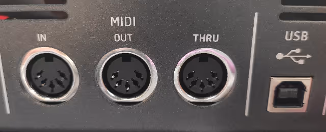 The back of a keyboard showing the three MIDI connections.
