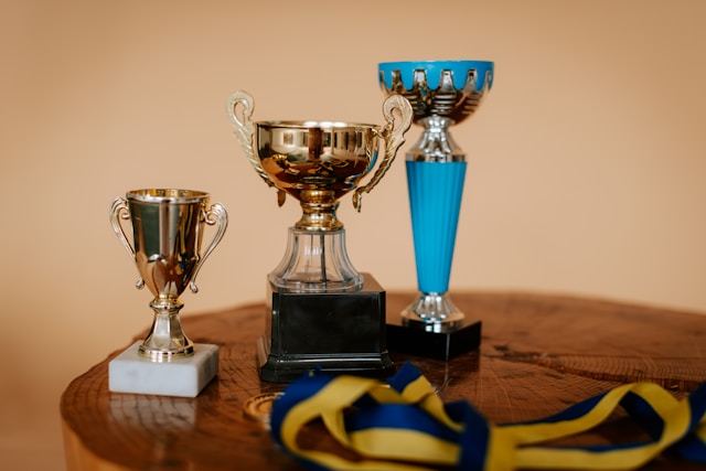 Traditional piano exam certificate and trophy representing structured learning milestones.