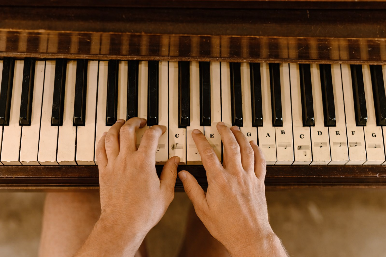Close up of piano keyboard keys with beginner identifying middle C note.