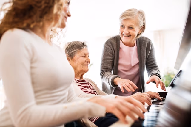 Person playing piano in a sunlit room looking relaxed and stress-free.
