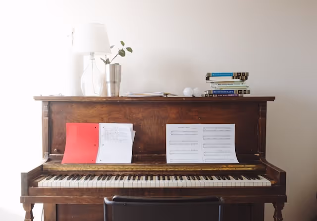 Wellness journal next to piano keys for habit stacking routine.