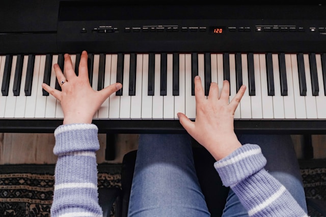 Focused piano student actively practicing at a piano
