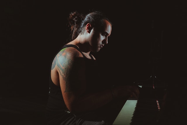 A person practicing piano looking thoughtful