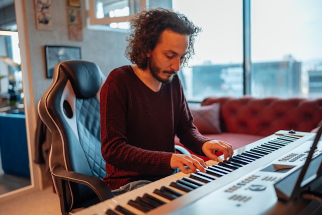 Person practicing piano alone at home on a digital piano
