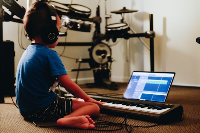 Student practicing on a MIDI keyboard with a piano learning app