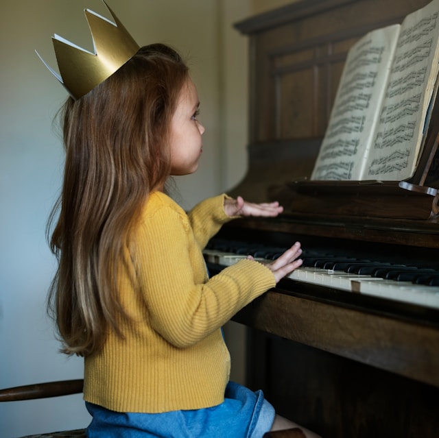 Beginner practicing piano while reading sheet music