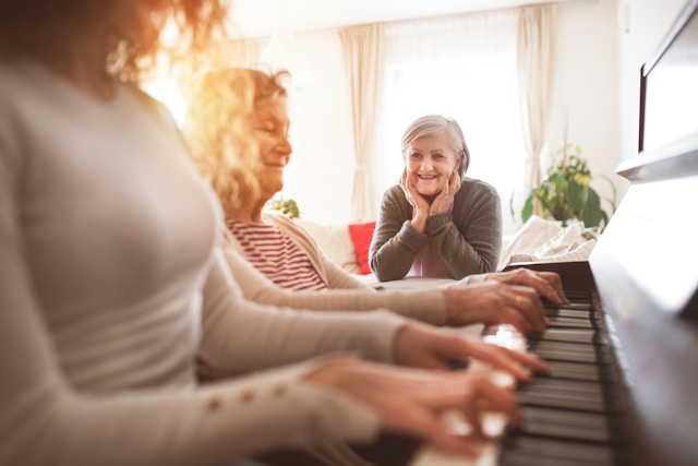 People smiling while practicing piano together