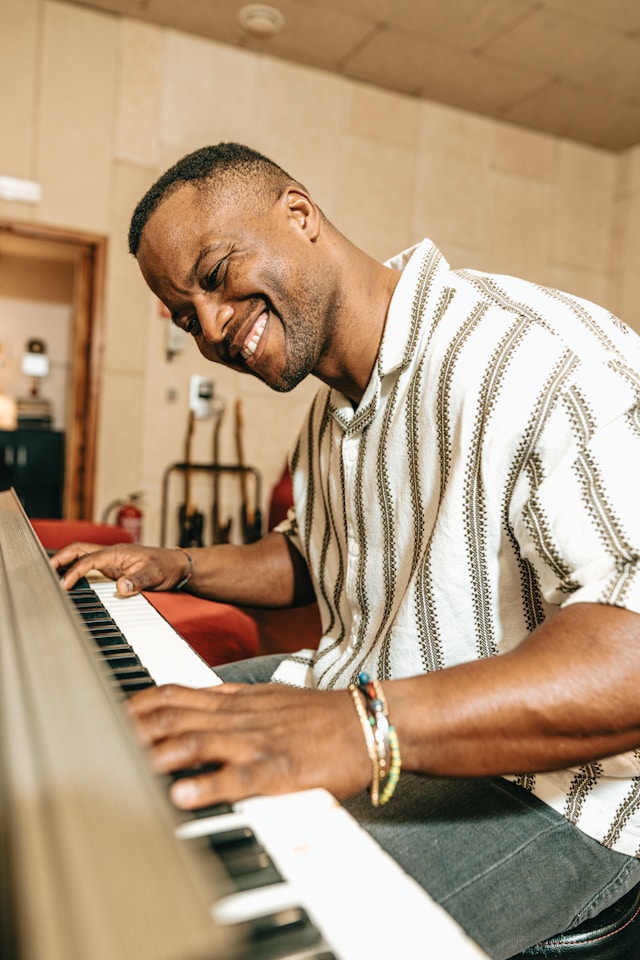 Person smiling and immersed in piano practice
