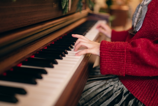 Person practicing piano with focused attention.