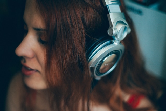Person relaxing while listening to music through headphones