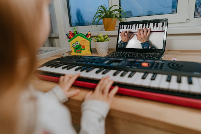 A girl using MuseFlow on a digital keyboard.