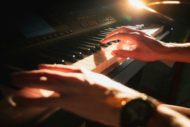 Someone playing the keyboard feeling meditative and in the groove.