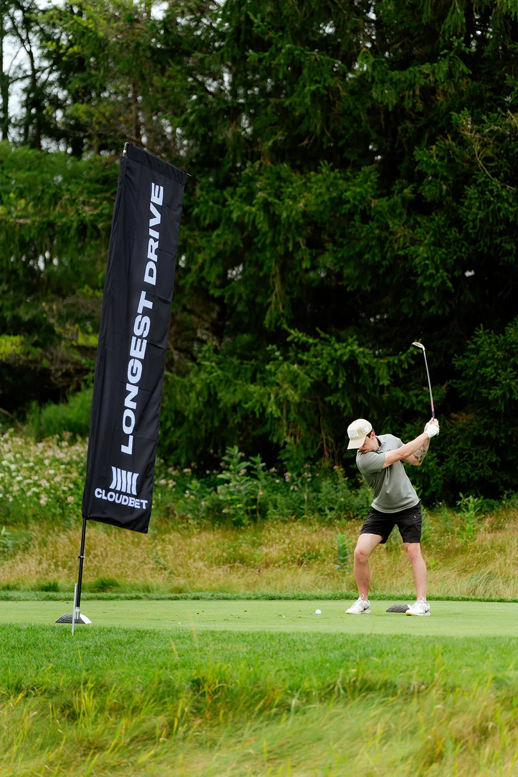 Cloudbet branded teardrop flag on golf course